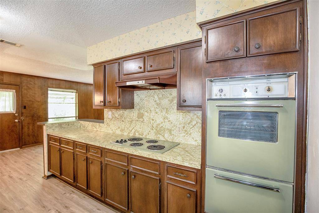 A standout feature is the unique green double oven, adding a pop of color and a touch of vintage flair to the space.