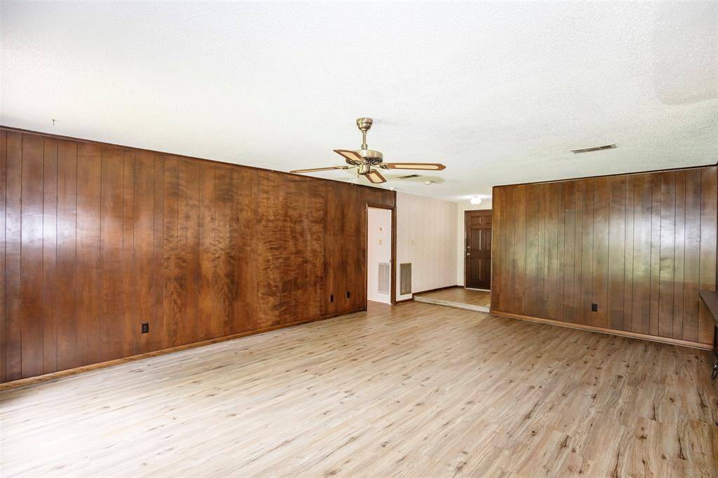 The family room features rich dark paneling that adds warmth and character to the space.