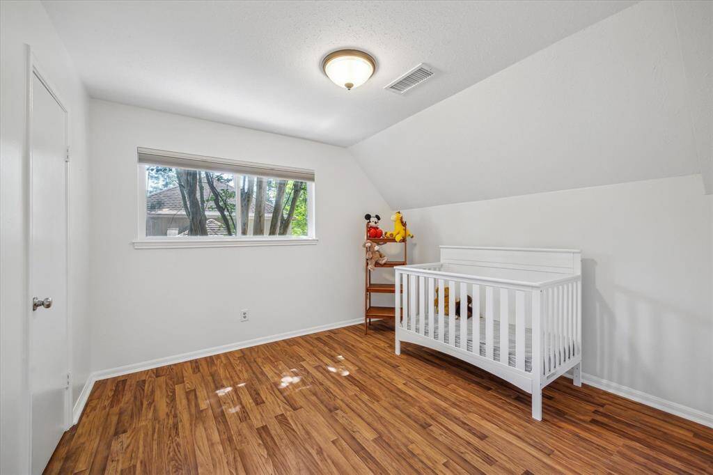 Well-lit child’s room offering a clean and comfortable space.