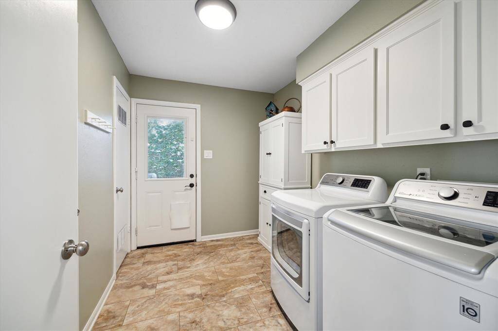 Utility room offering bright workspace and convenient storage.