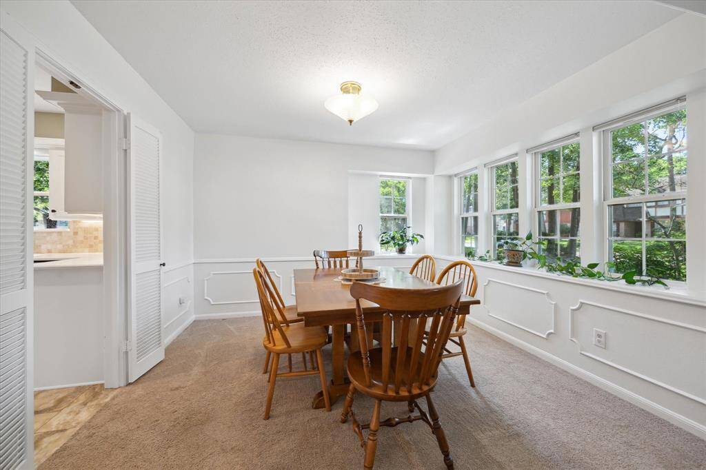 Light-filled dining space featuring elegant wainscoting.