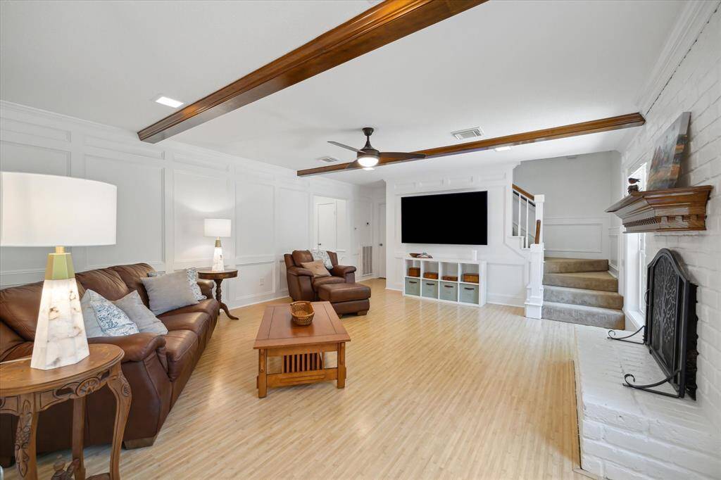 Spacious living room with fireplace and classic wainscoting.