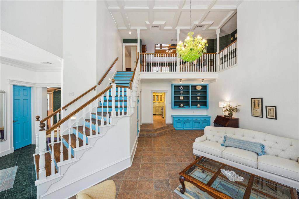 Open concept showcases the family room with built ins, a half bath and the upstairs.