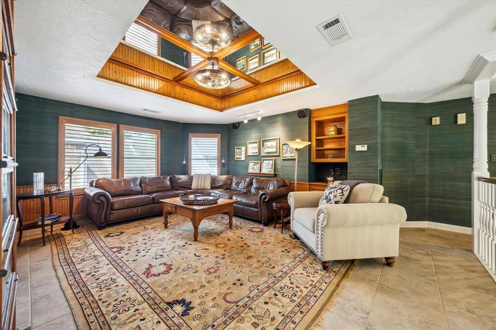 The den is spacious but cozy with custom built ins.