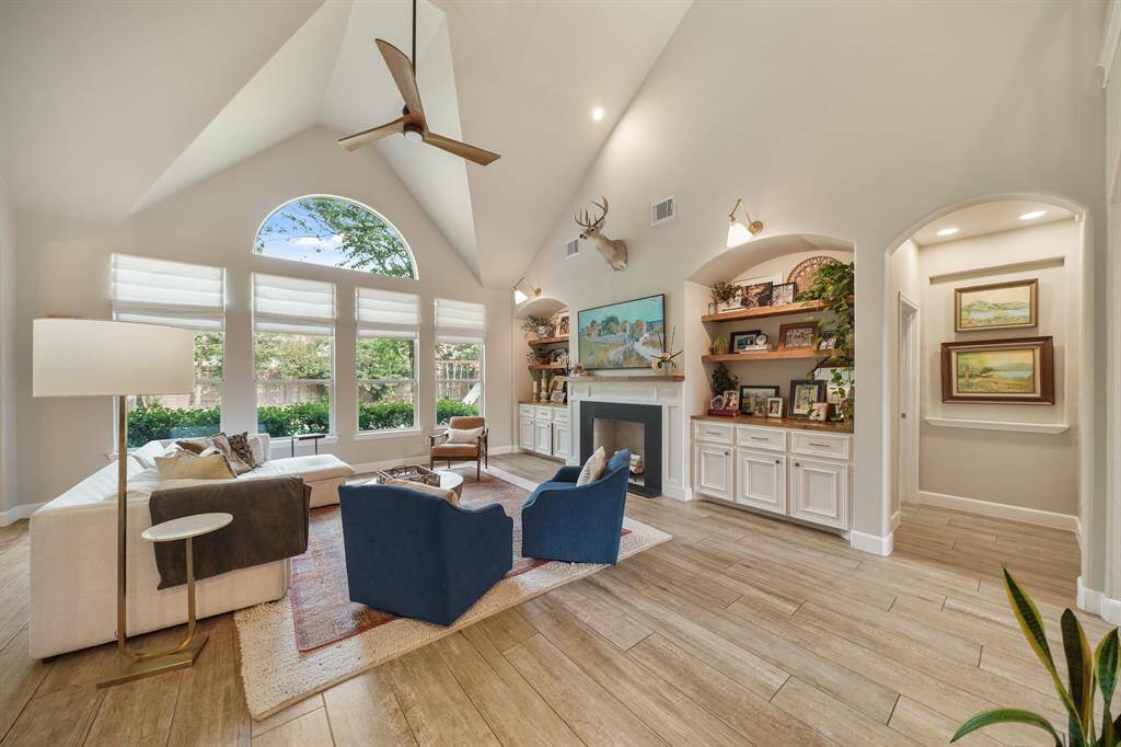 The Family Room ceiling makes a statement and the large windows along the back of the house let in natural light for the entire space
