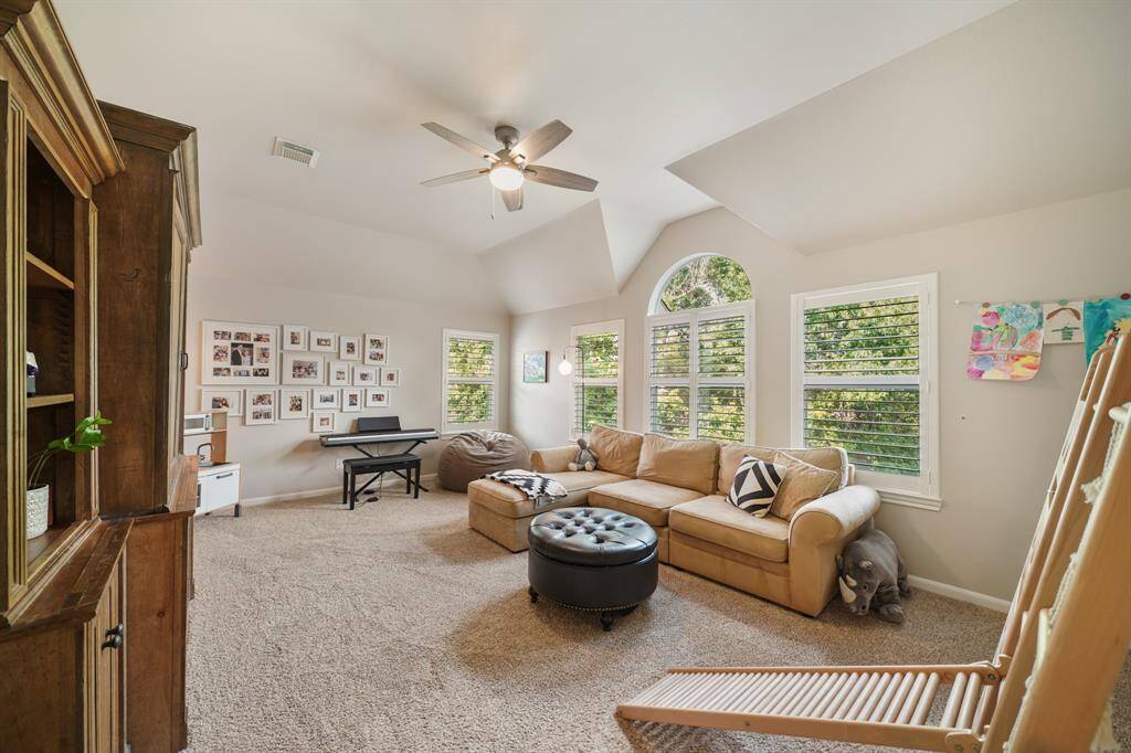 Upstairs Gameroom features a vaulted ceiling, plenty of natural light, and so much space for whatever you need