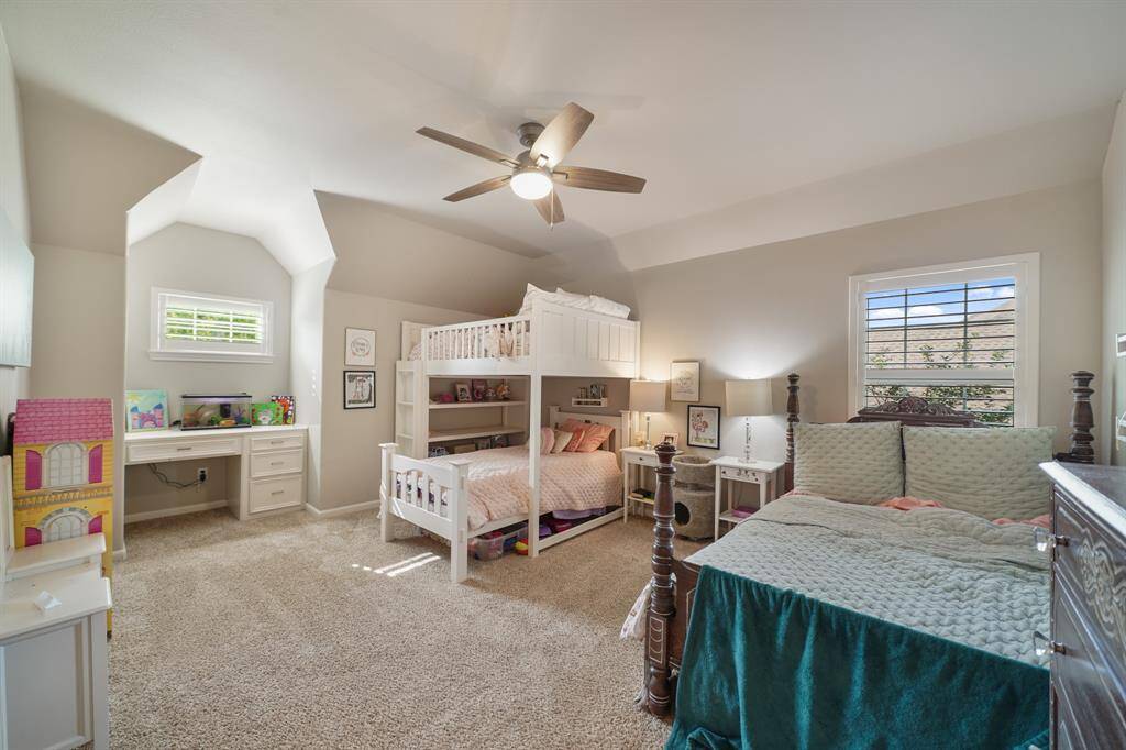 This carpeted, upstairs Secondary Bedroom has a built-in desk in the bay window
