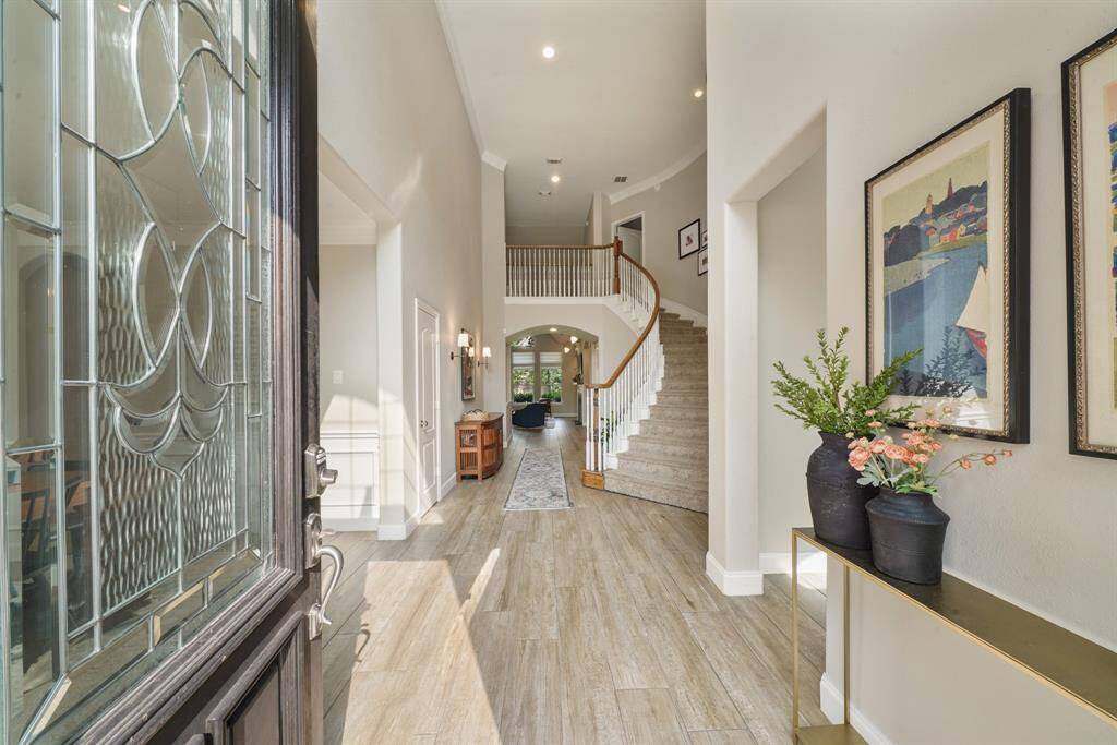 Through the solid wood, leaded glass front door you are greeted by high ceilings and a neutral color palette providing an open and airy space