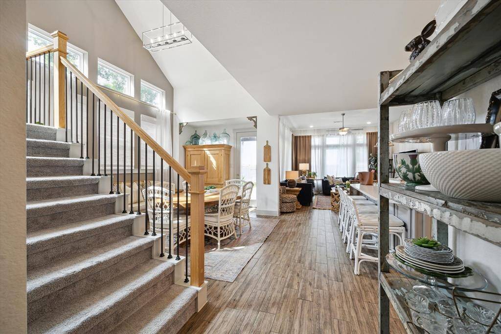 This charming area of the living space showcases soaring ceilings, beautiful natural light, and a lovely view of the backyard, ideal for enjoying peaceful moments or gathering with family and friends.