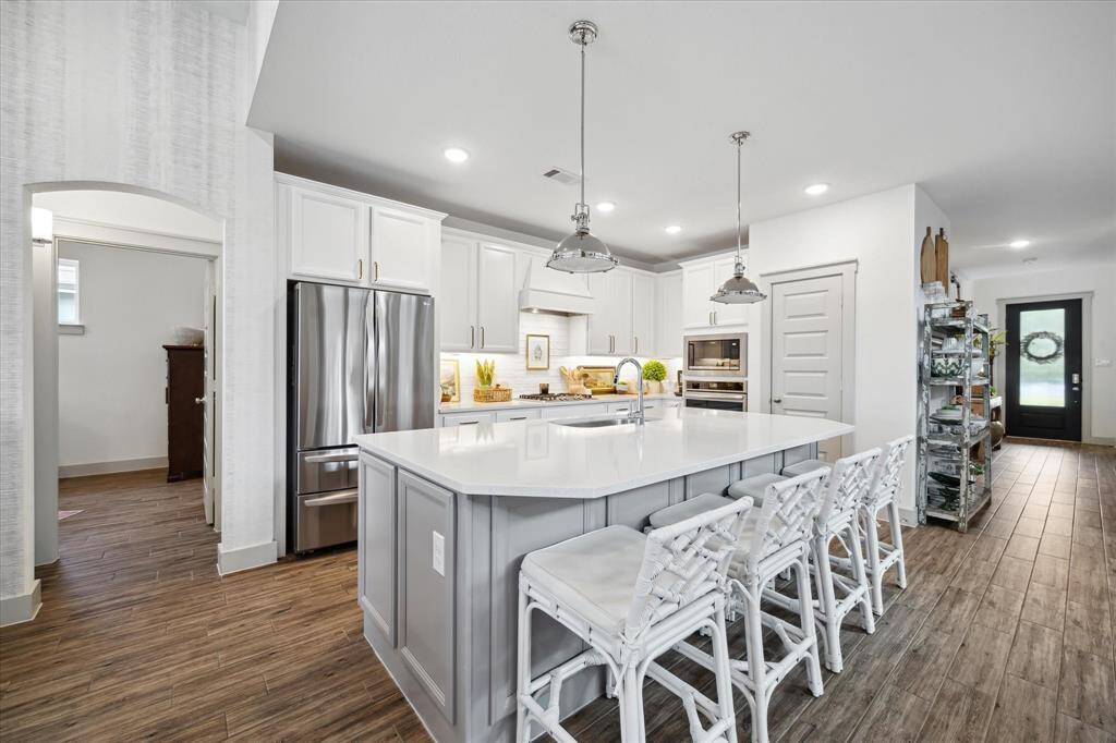 Dine in style beneath soaring ceilings, this open dining area flows seamlessly into the kitchen for effortless entertaining.