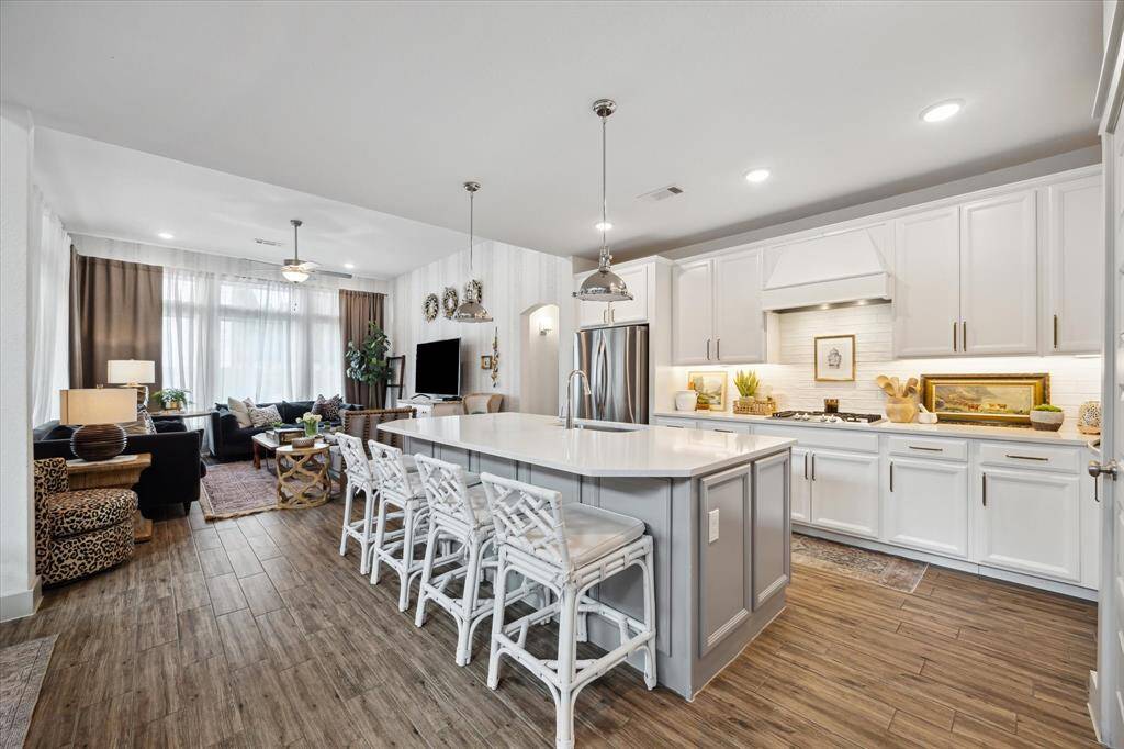 Light-filled and spacious, this kitchen combines modern luxury with everyday functionality, including a large island perfect for casual dining.