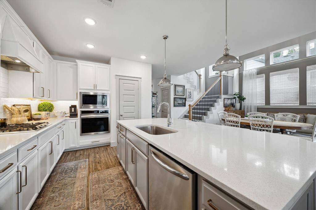 A bright, expansive white Silestone island with sink perfect for prep, serving, and gathering.