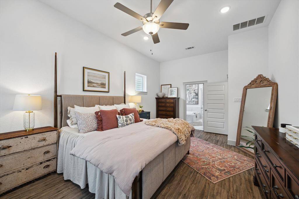 Beautiful primary bedroom showcasing its generous space, abundant natural light, and a clear view of the en-suite bathroom location.