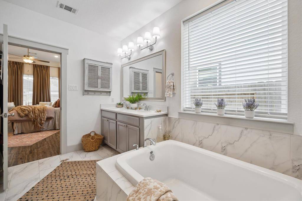 Every day feels like a spa day in this tranquil en suite with a large soaking tub and sleek standing shower.