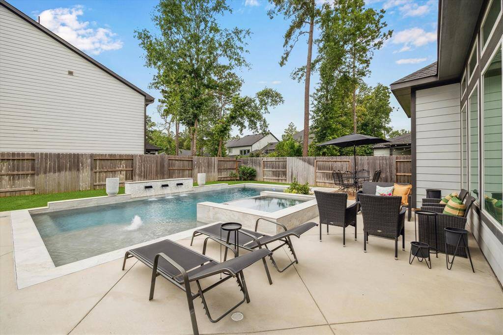 Backyard pool living with the added comfort of a privacy fence for ultimate seclusion.