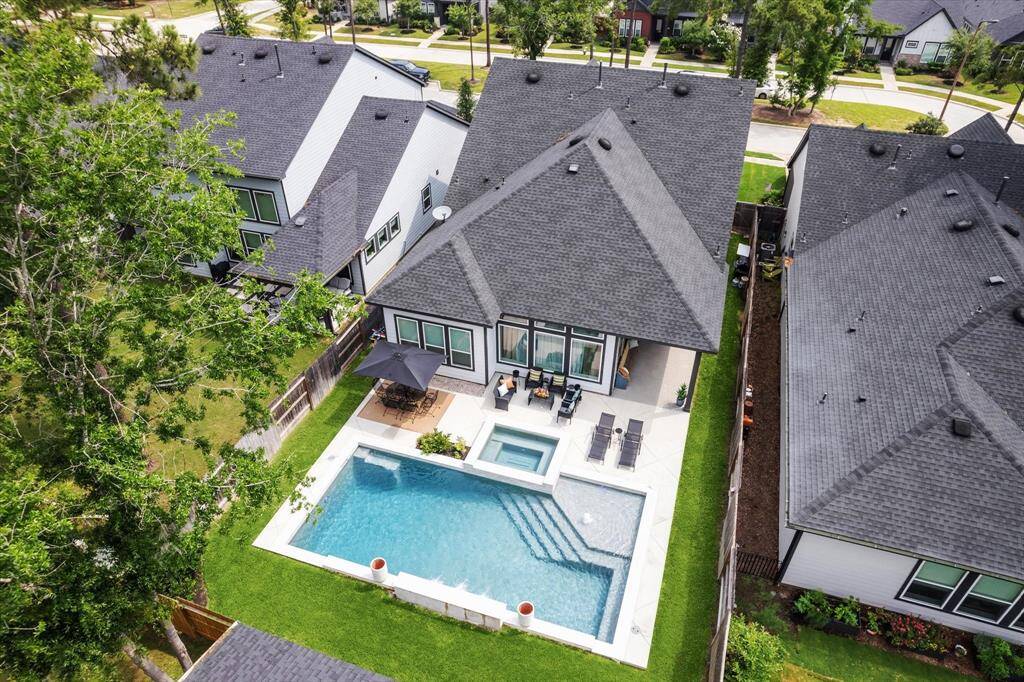 Aerial view of this beautiful property, showcasing the backyard and surrounding area.