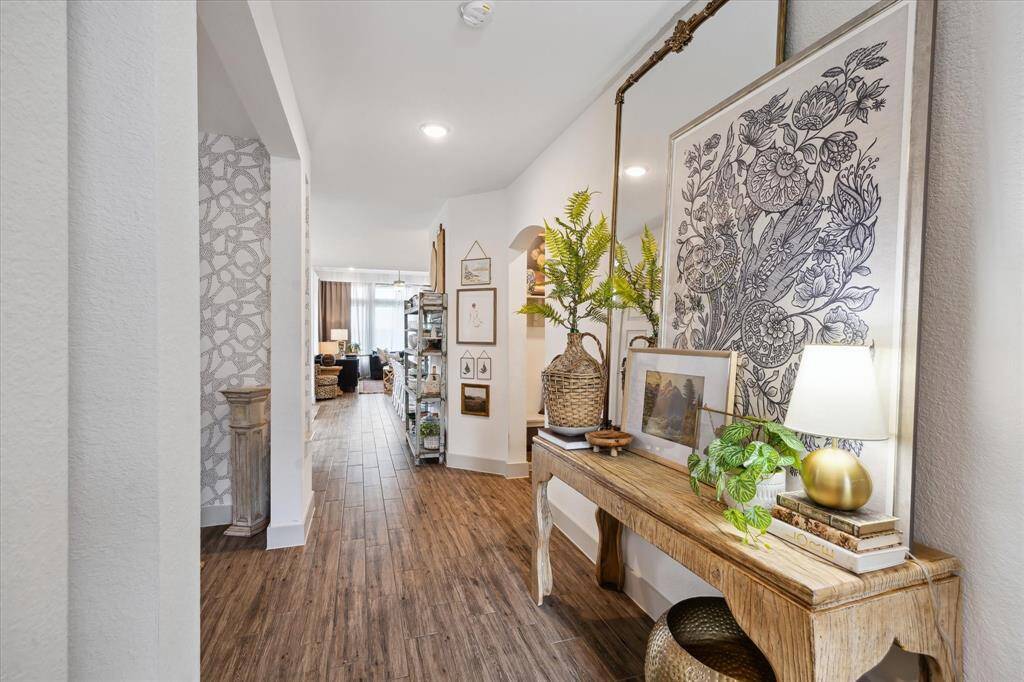 Spectacular view of the entryway foyer showcasing the home's exceptional craftsmanship and elegant details. Designed with modern sophistication and timeless style, this lovely home in Woodforest is truly elevated living.