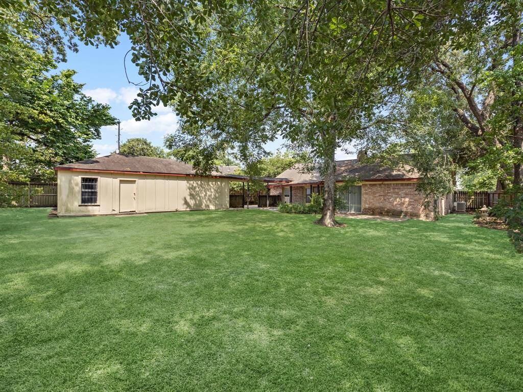 Huge backyard ready for your family and friends. Detached garage with extended woodshop area and covered walkway to home entry.