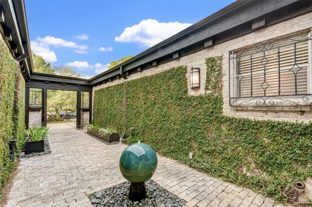 View looking towards entry gates. Ivy covered courtyard and bubbling fountain offer serenity upon entering