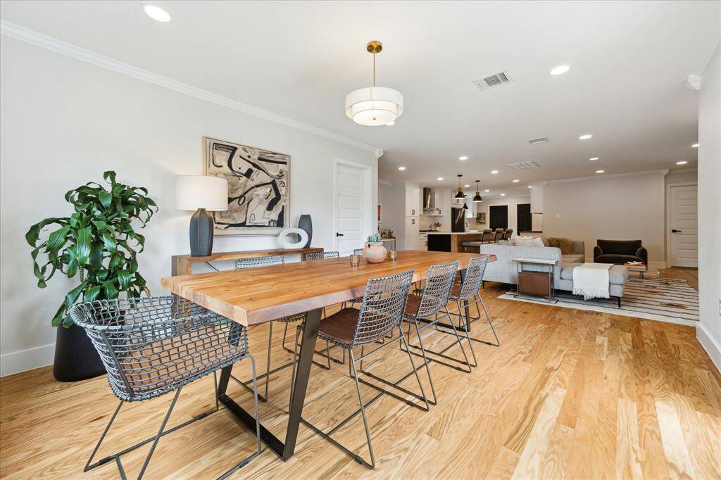 An alternate view of the dining area reveals its connection to the family room. Just through the door on the left lies a flex space—ideal for a home office, gym, or creative studio.