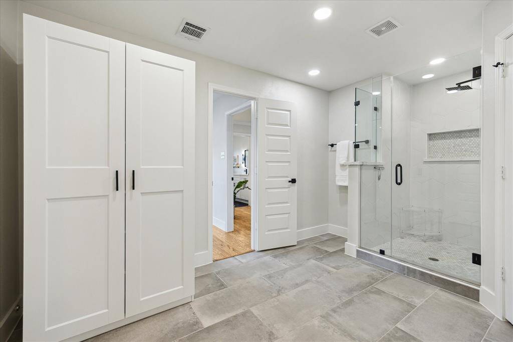 To the left, a walk-in closet provides ample storage, complemented by a floor-to-ceiling cabinet—perfect for linens and accessories.  Note that all interior doors have been replaced.