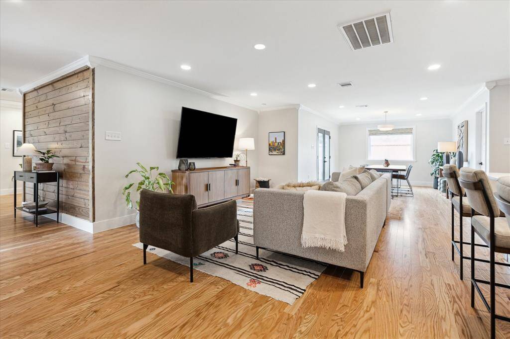 Take note of the open floor plan, enhanced by abundant natural light streaming through double glass doors and a large picture window. Recently installed custom shades by the current owner in all rooms.