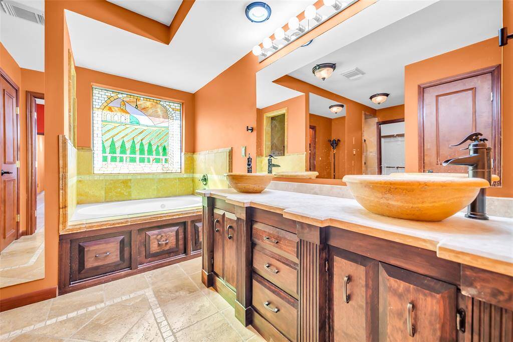 Primary bathroom with dual sinks and jetted tub.