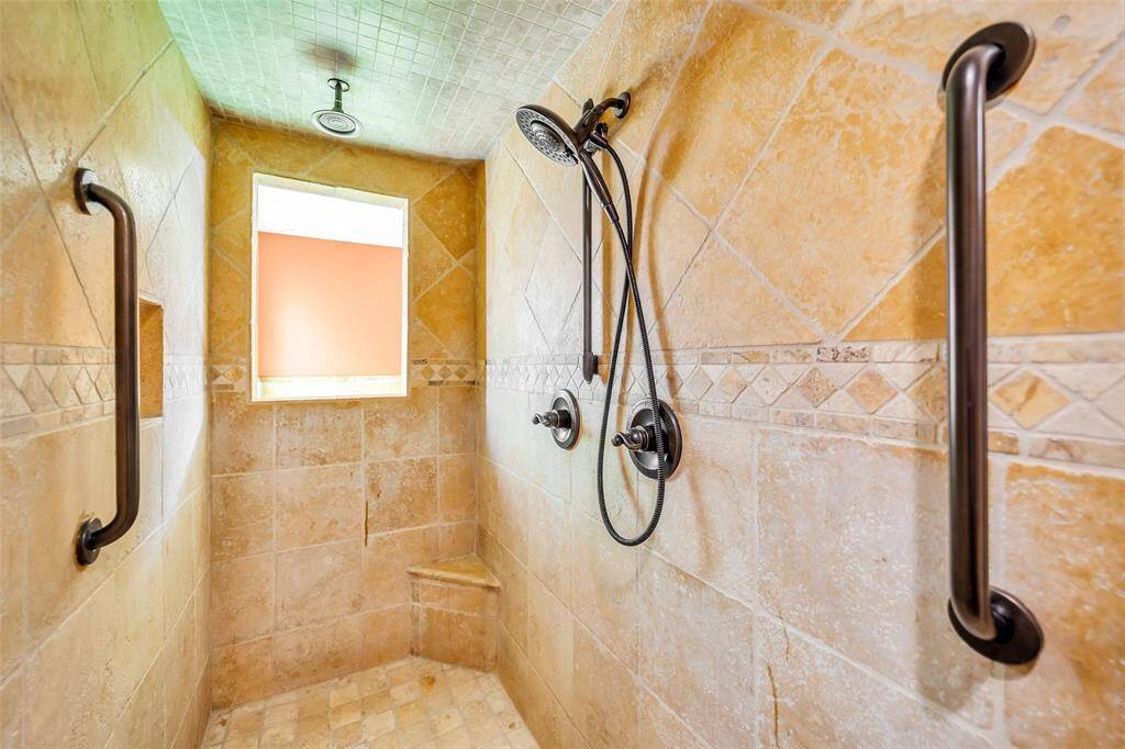 Walk in shower with overhead shower head.