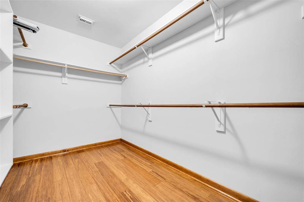 Spacious primary bedroom walk in closet