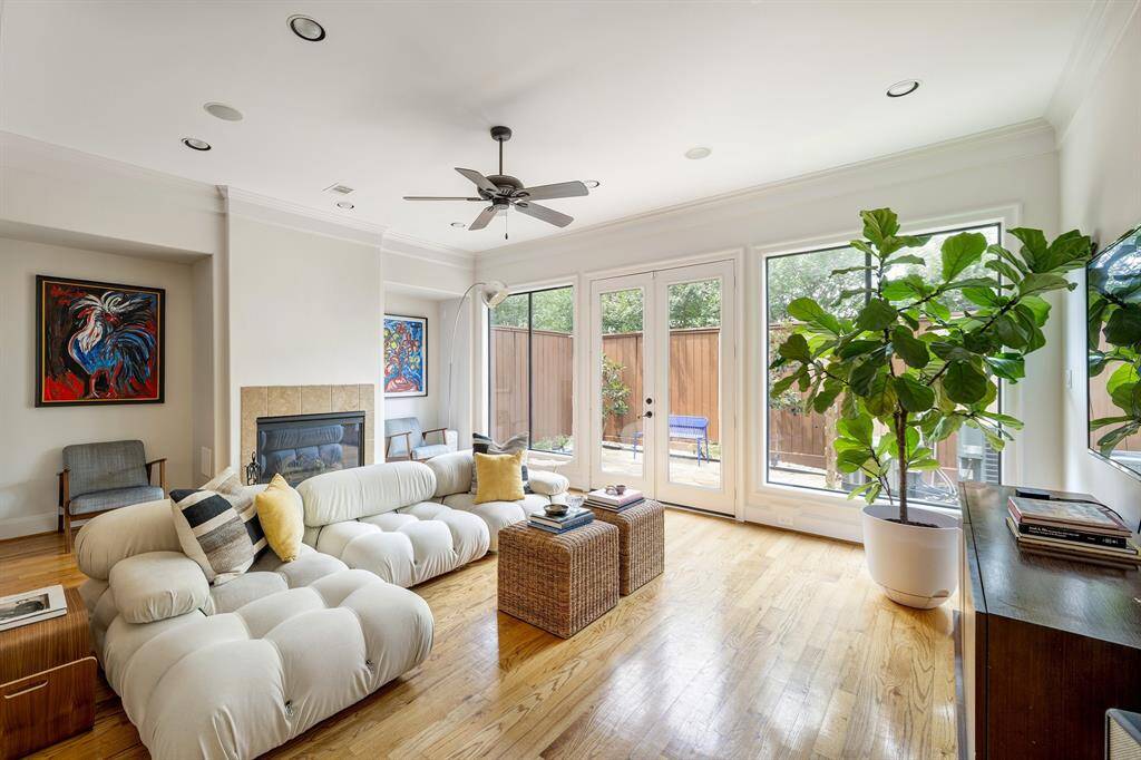 So much natural light! Enjoy this living space with room for art and warmth from the fireplace.