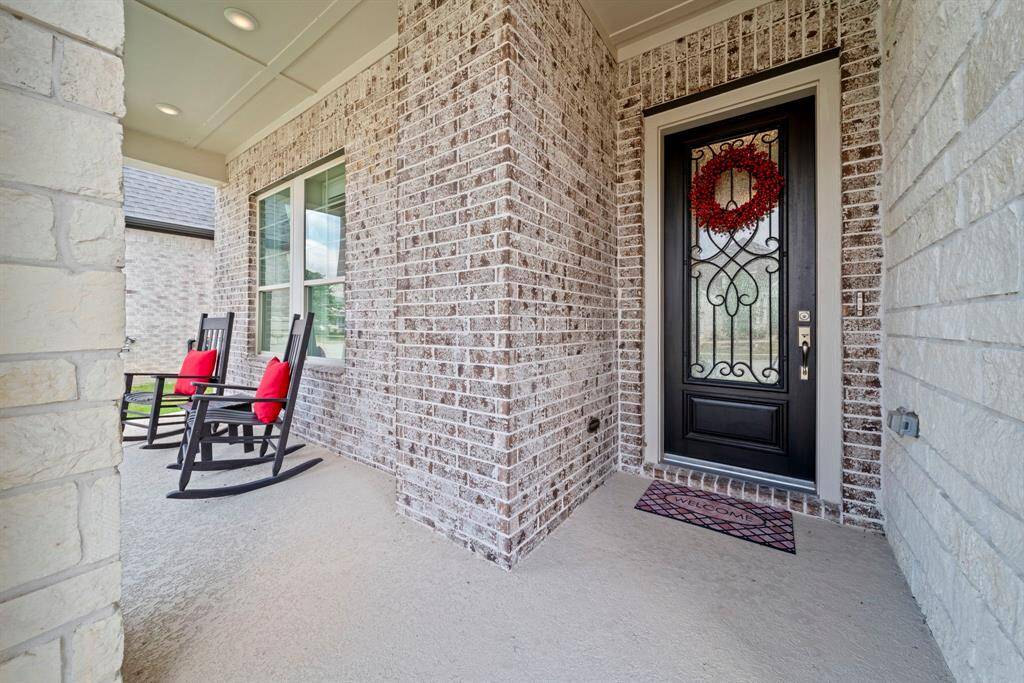 The friendly covered porch has room for deliveries and "porch sittin"
