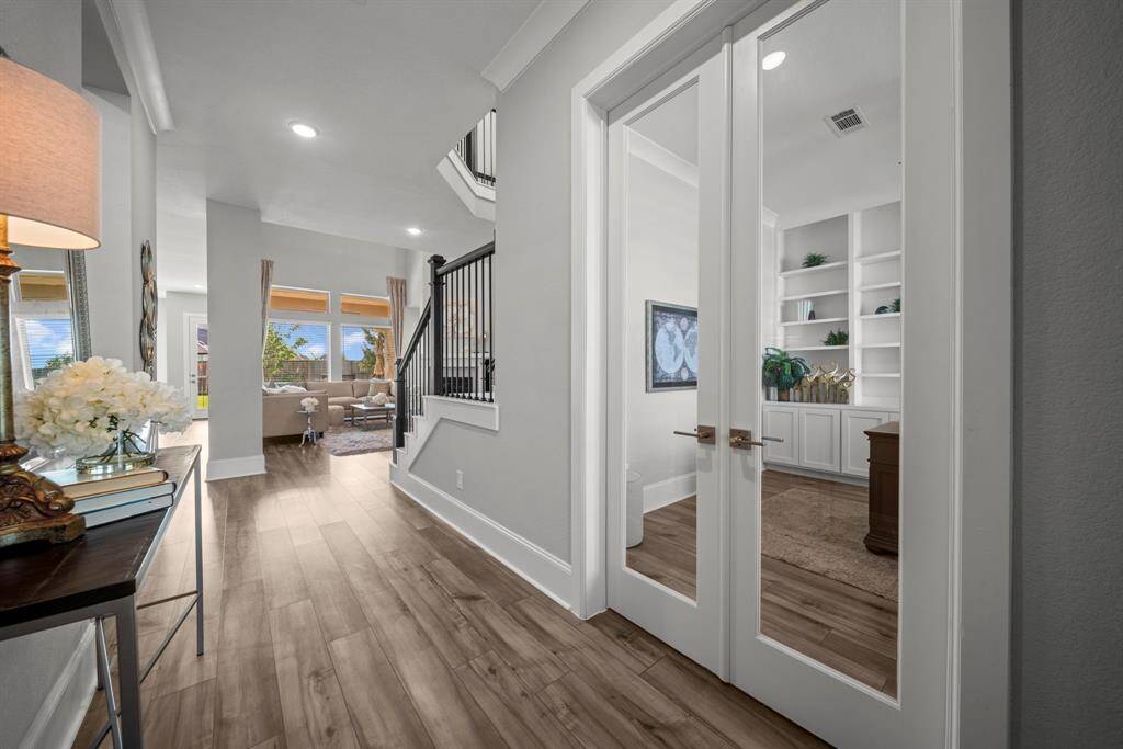 As you enter the home the custom study is on the right and the guest suite is to the left