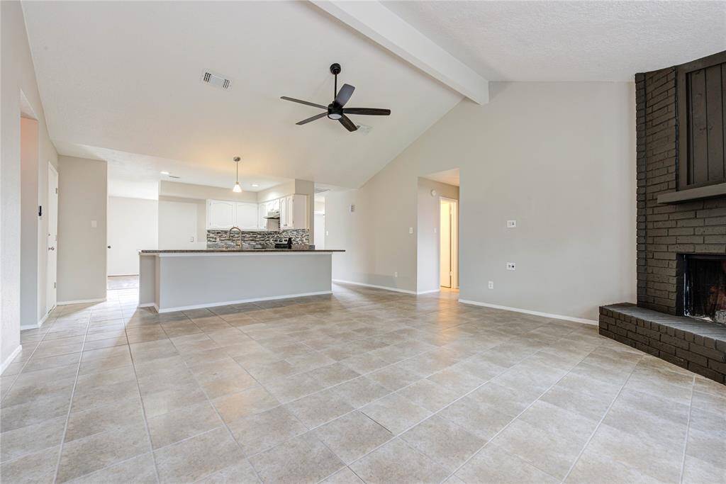 Step into a spacious living area filled with natural light and charm.