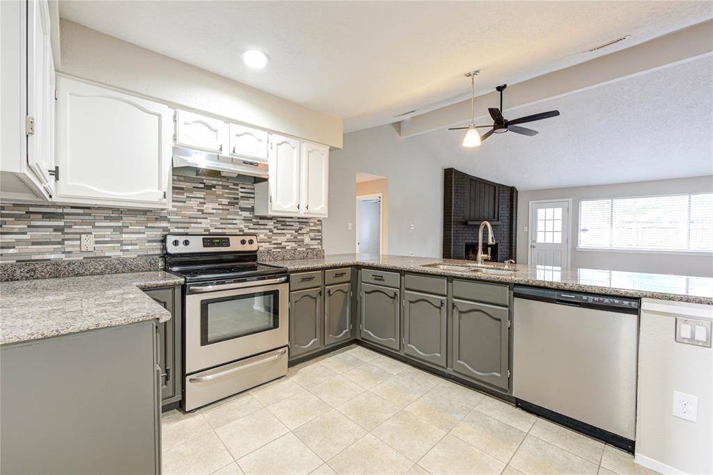 Enjoy cooking in a beautifully updated kitchen with granite countertops, plenty of cabinet space, and a convenient layout.