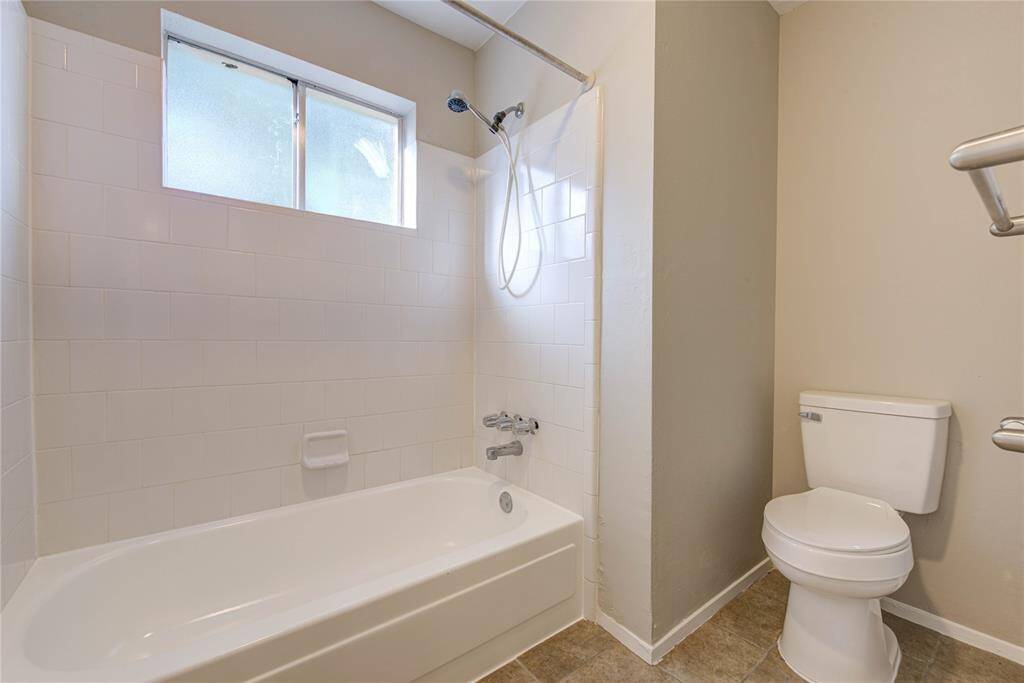 This updated hall bathroom is perfect for kids or guests, featuring a modern vanity, easy-to-clean tile surfaces, and a convenient tub/shower combo.