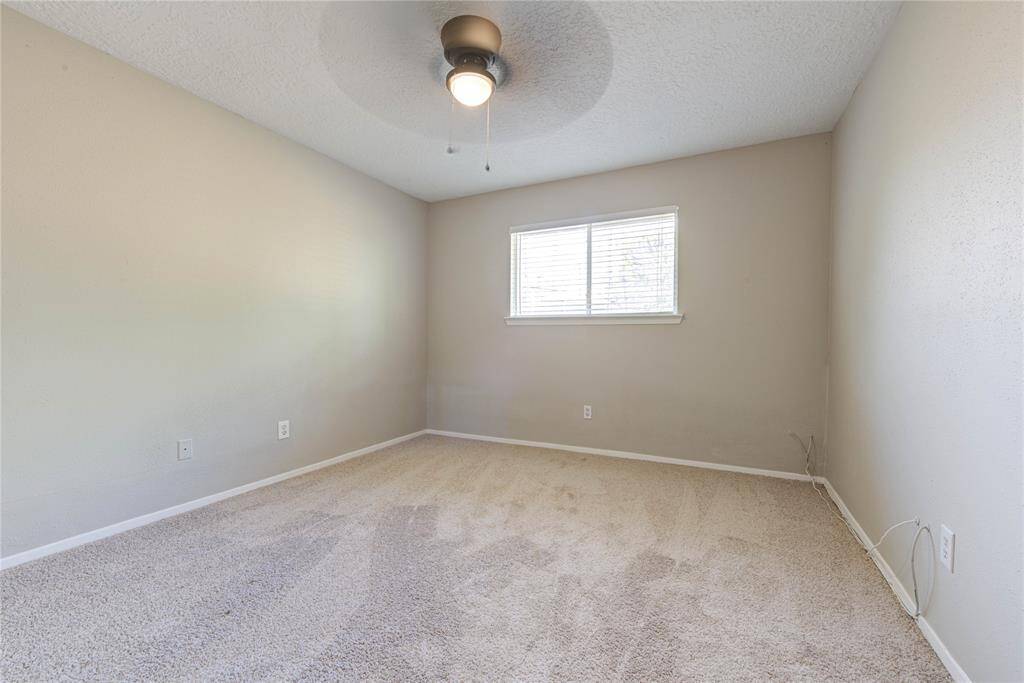 Each secondary bedroom is well-sized with ample closet storage, tile flooring, and plenty of natural light—perfect for kids, guests, or a home office.