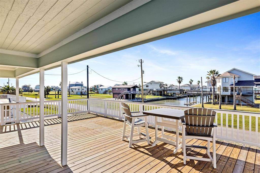 Deck with a residential view and a water view