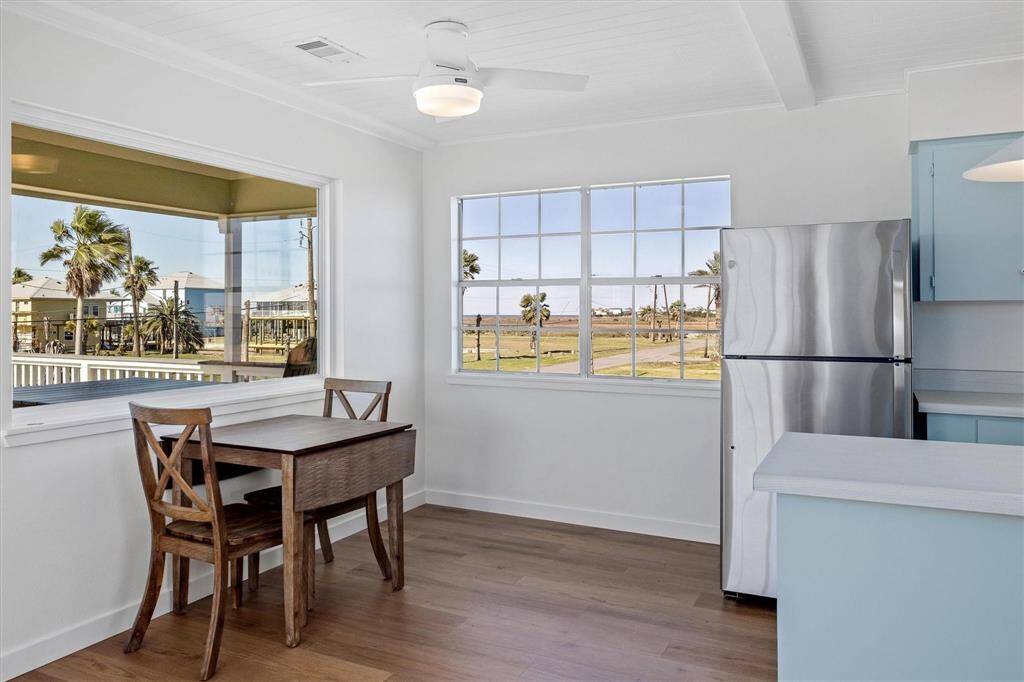 Dining space featuring beam ceiling, wood finished floors, visible vents, and baseboards