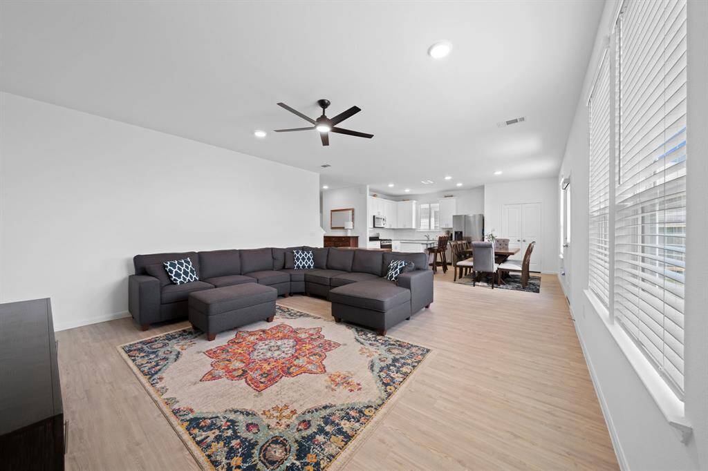 The home boasts an open floor plan, seamlessly connecting the kitchen, dining, and living area.