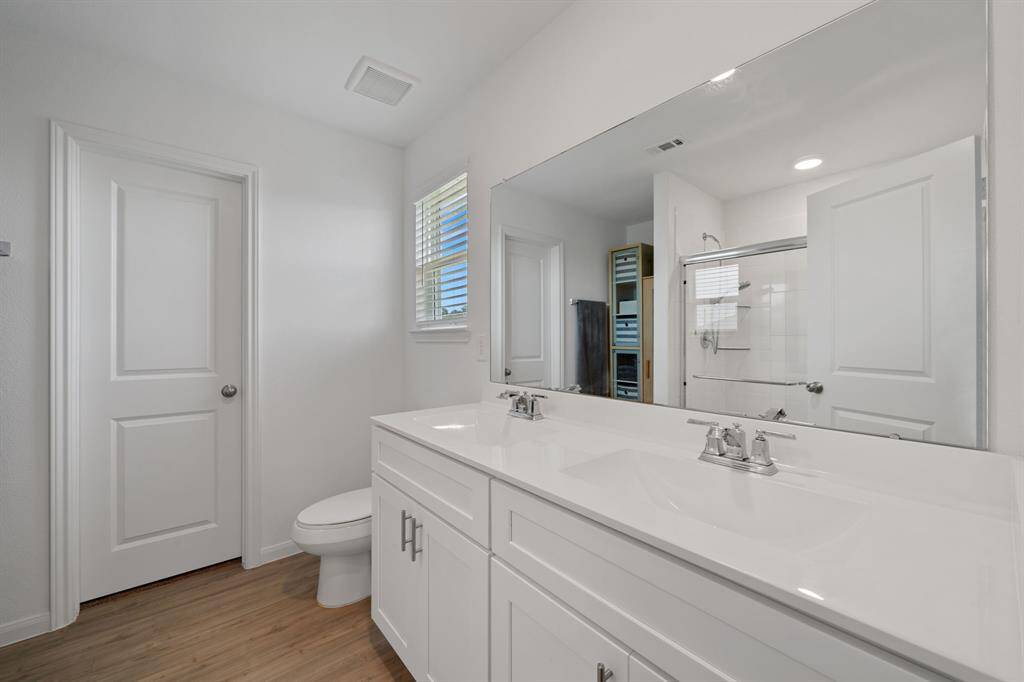 Elegant dual vanity setup offers ample space and style in the primary bath.