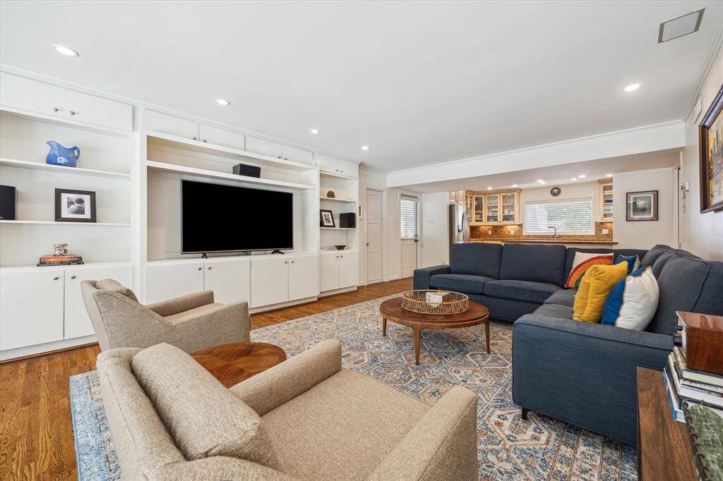 The den wraps around to the living room that is also open to the kitchen.
