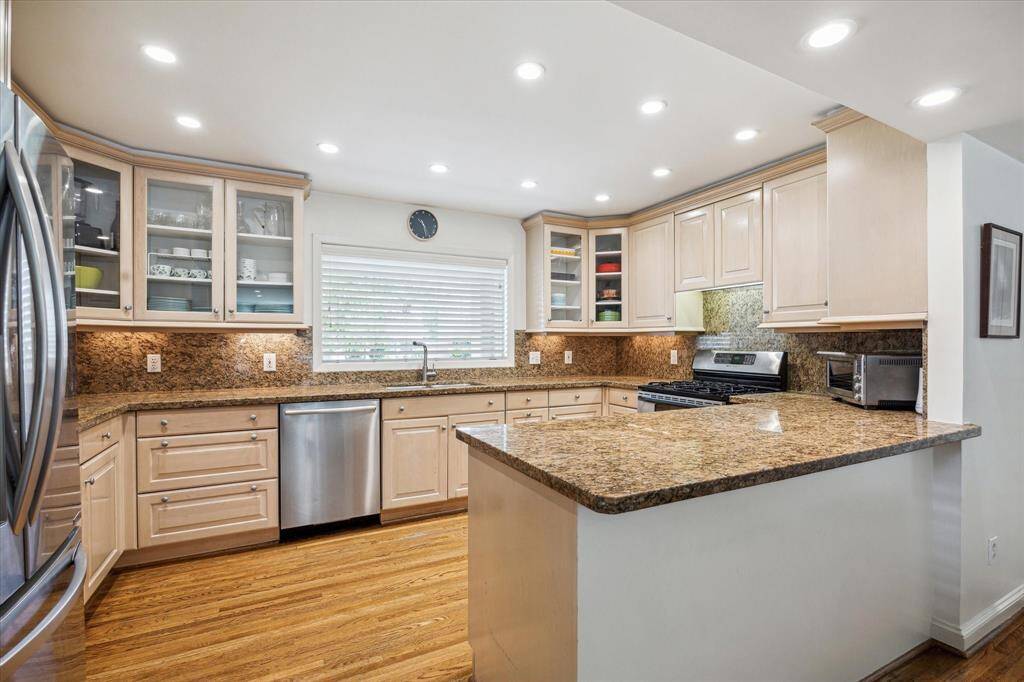 The kitchen enjoys quintessential windows above the sink for front yard views.