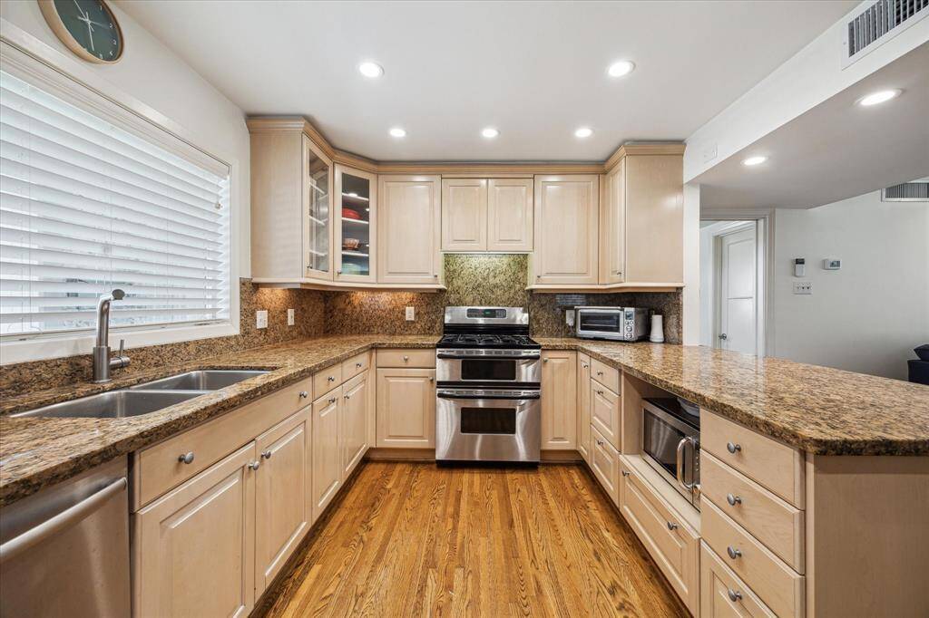 An efficient kitchen with ample cabinets and gas stove.
