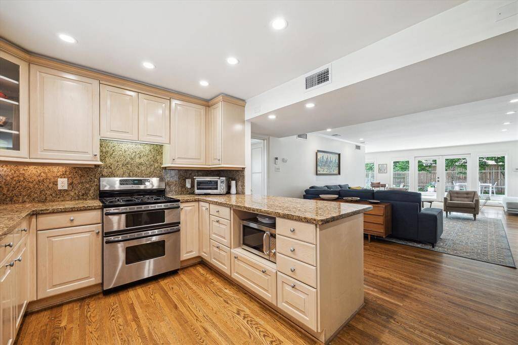 The living room seamlessly flows into the sleek kitchen.