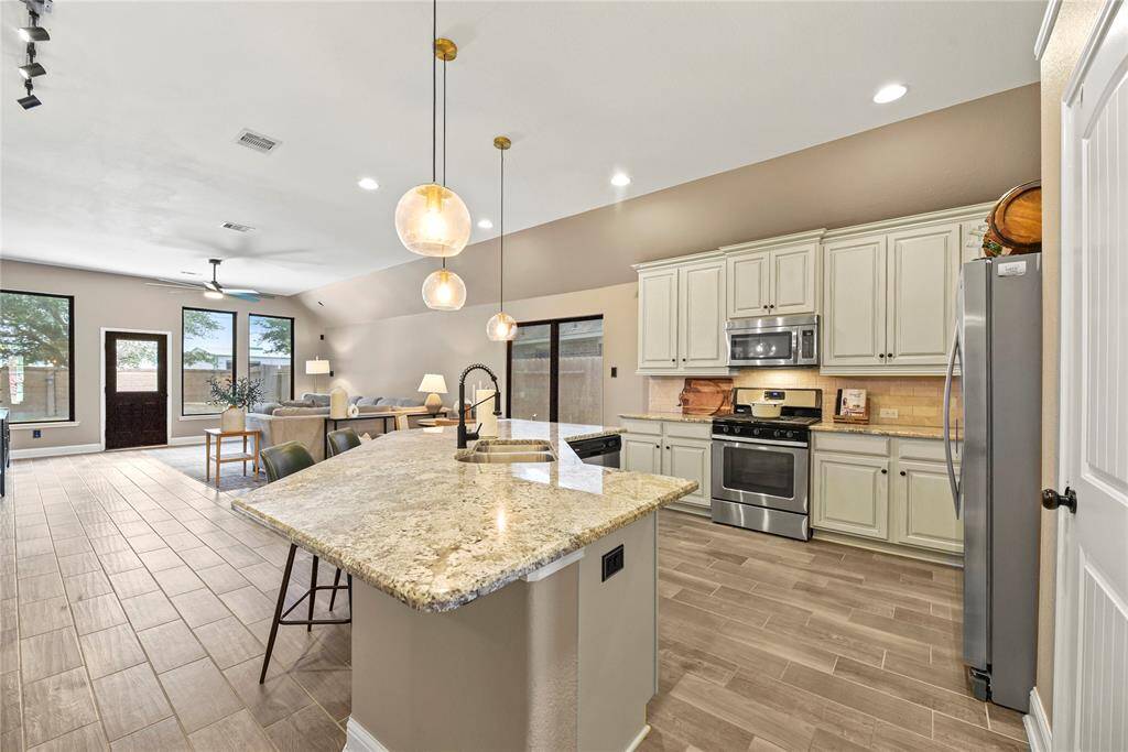 In this open concept design, the kitchen serves as the heart of the home, where meals are prepared, conversations flow, and memories are made.