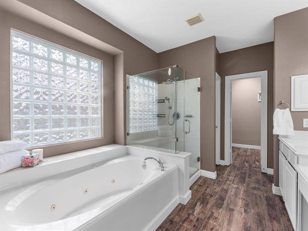 There's separate tub/shower and frameless glass for a modern look