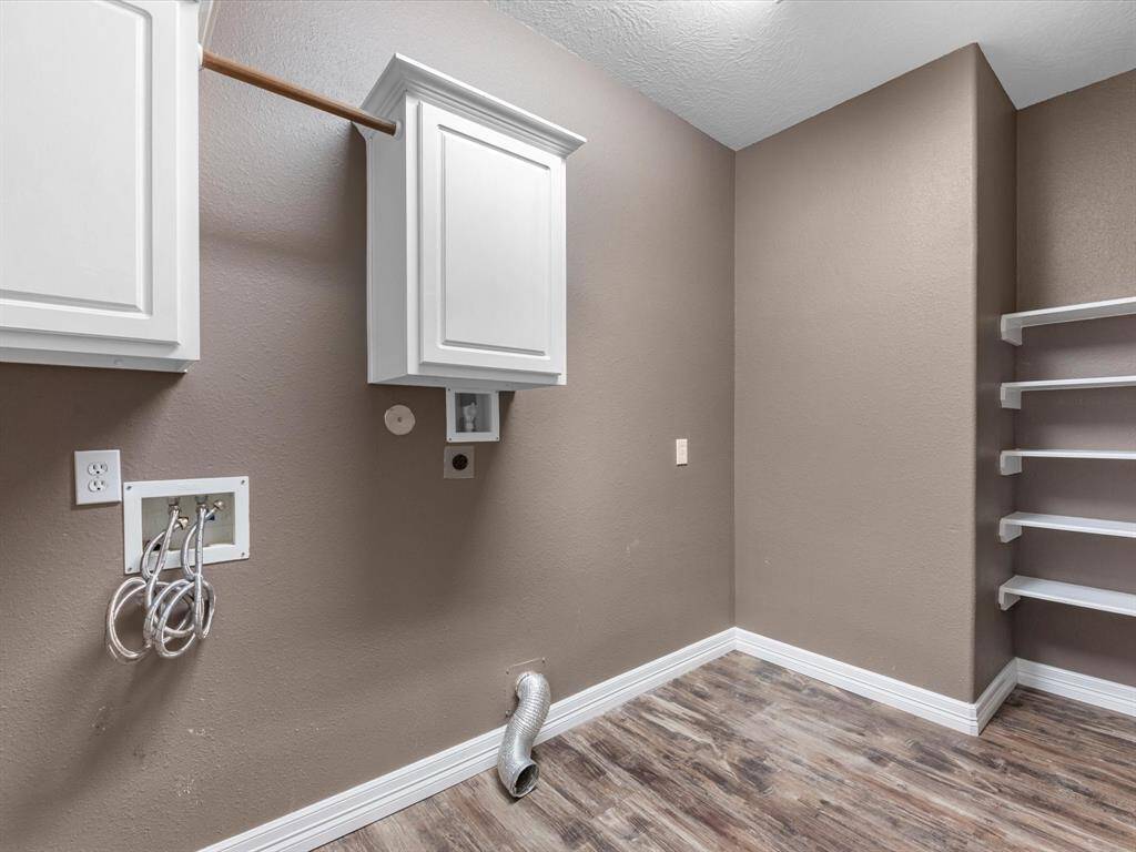 The laundry is downstairs and tucked under the stairs. It's a large room with storage