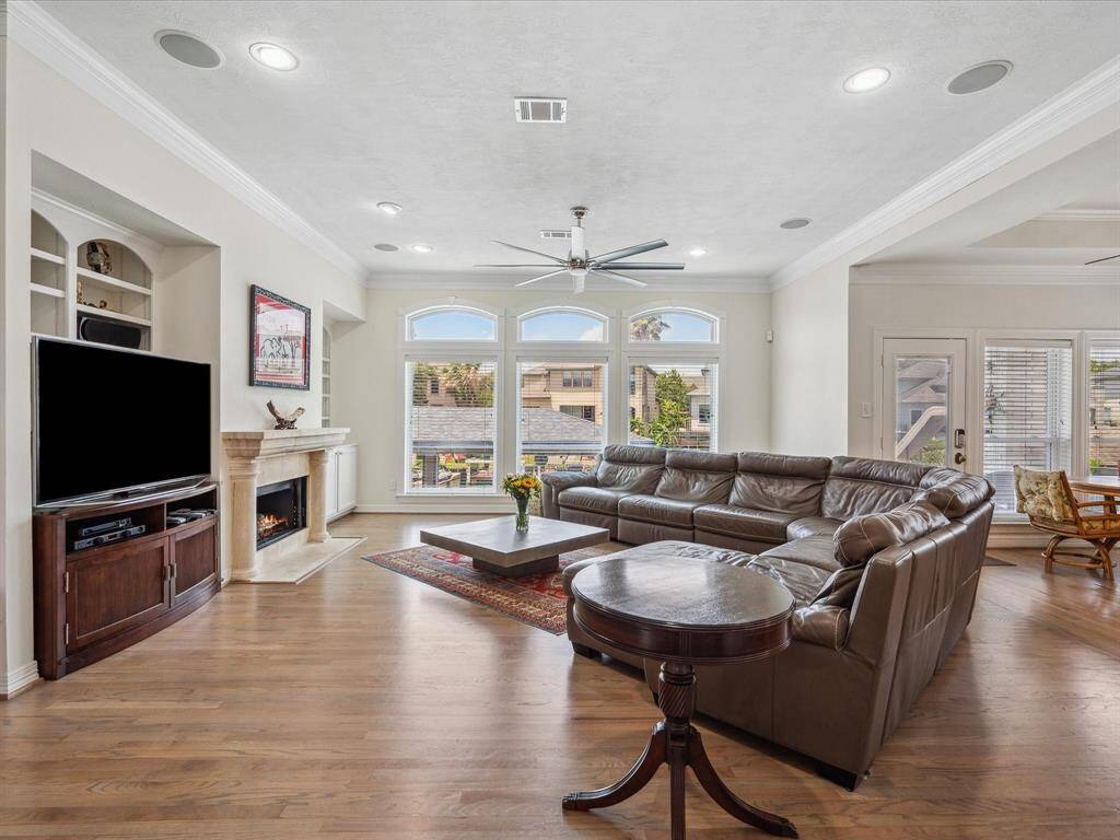 THE DEN IS DESIGNED FOR ENTERTAINING WITH BUILT-IN SPEAKERS, BUILT-IN ENTERTAINING CENTER AND CAST STONE FIREPLACE.