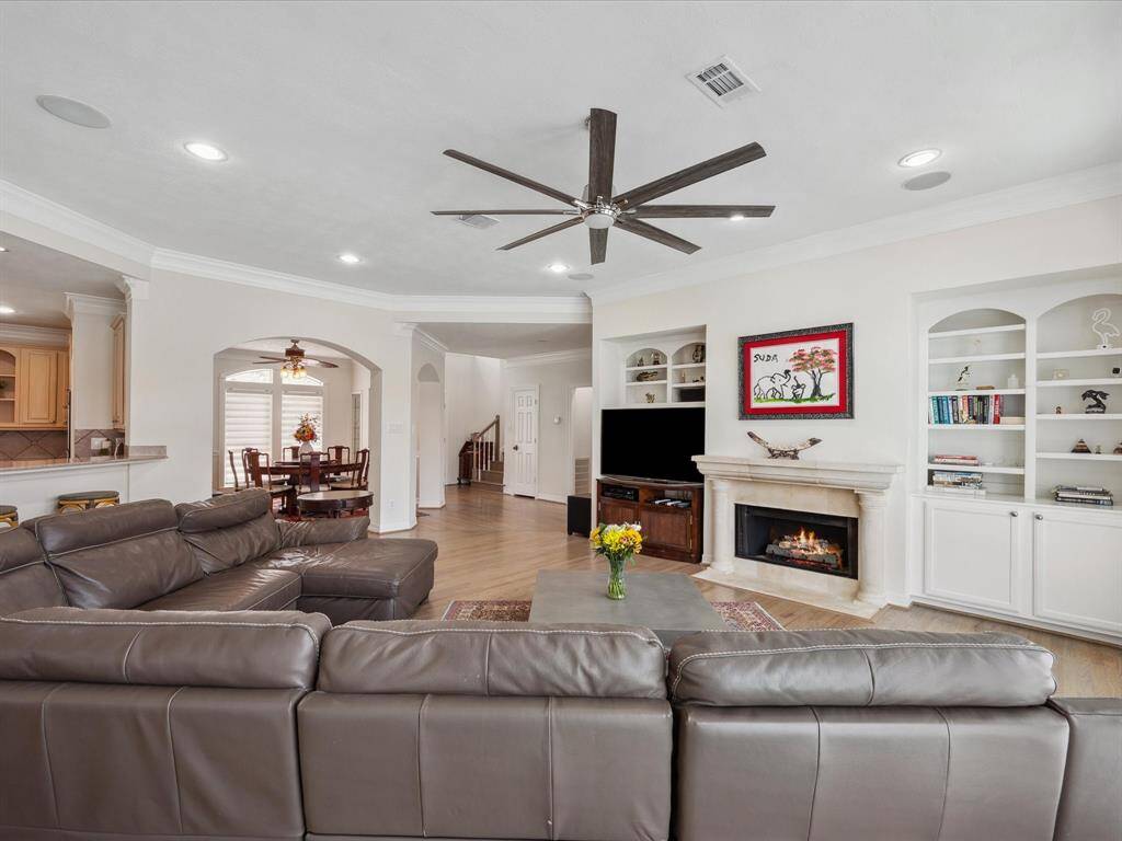 CUSTOM BUILT-INS SIT ON BOTH SIDES OF THE CAST STONE FIREPLACE.