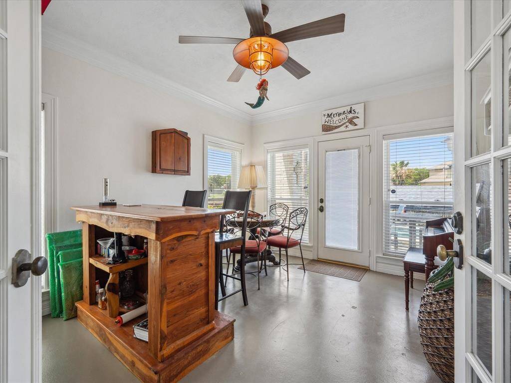 FIRST FLOOR OFFICE WITH FRENCH DOORS, CURRENTLY USED AS A BAR, FEATURES A PRIVATE PATIO OPENING TO THE POOL.